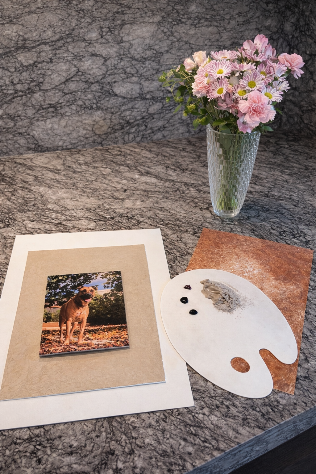 Artist studio setup — photo reference, plaster palette, and fresh flowers. The raw ingredients of an Ash & Earth memorial.